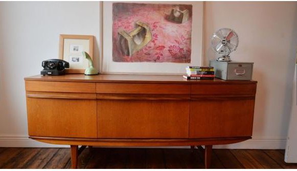 A teak sideboard displaying drawings by Art Spiegelman for Maus in the home of design historian Linda King in North Strand, bought when she lived in New York, and a mint green Ericsson Ericofon bought in Turin. Photograph: Alan Betson.