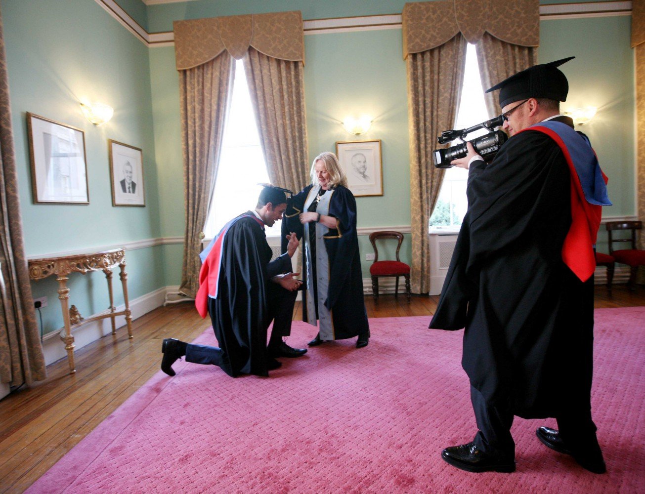 IADT President Dr. Annie Doona helps Niall Breslin with his mortarboard in advance of IADT Ceremony of Conferring